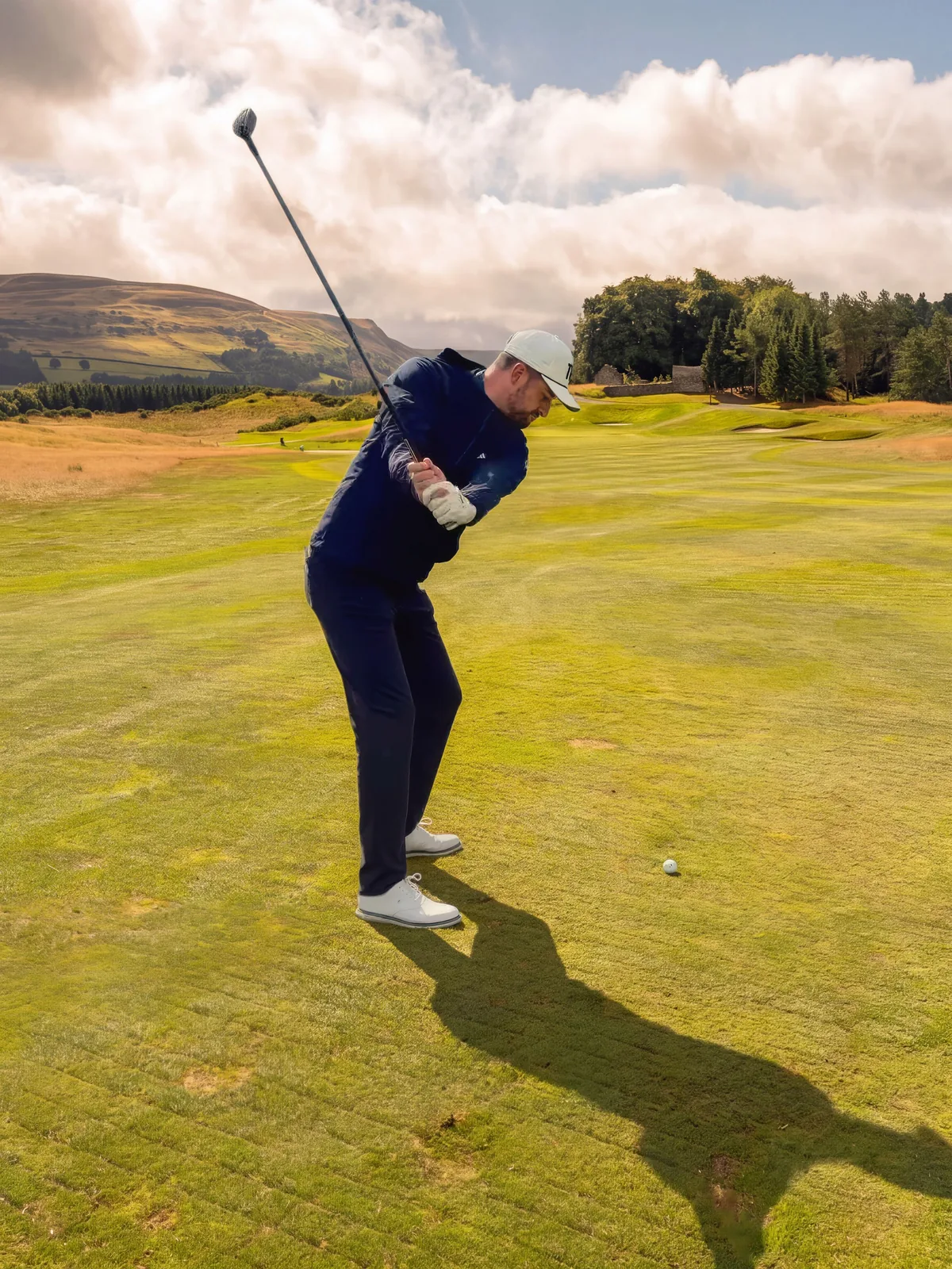 Euan near the top of his backswing on a Scottish course